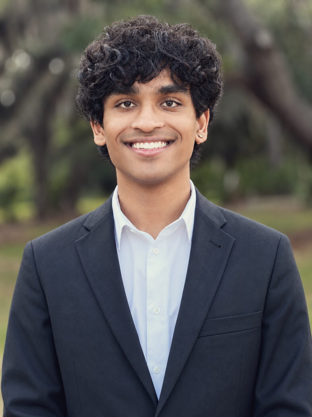 Arnav Bonigala, smiling, in a navy blazer